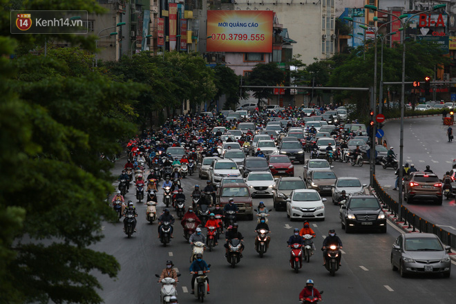 Ảnh: Đường phố Hà Nội và Sài Gòn đông đúc trong ngày đầu tiên nới lỏng cách ly xã hội, người dân thủ đô chật vật đi làm dưới mưa - Ảnh 10.