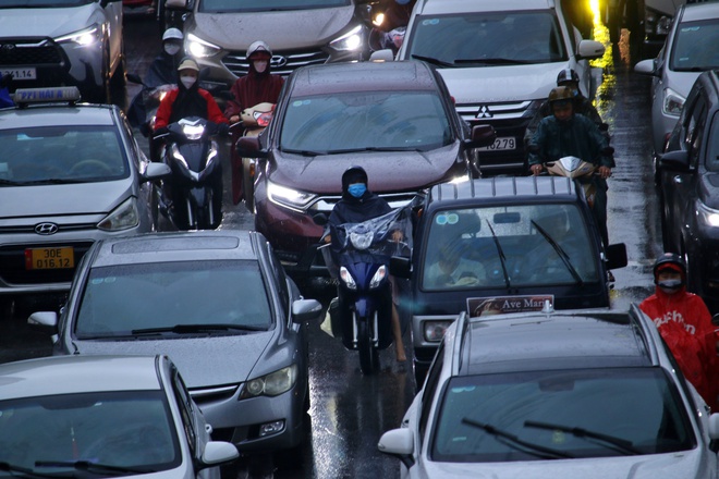 Đường phố Hà Nội ùn tắc nghiêm trọng trong ngày mưa lớn, người dân vất vả di chuyển đi học, đi làm - Ảnh 7.